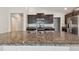 Kitchen island with granite countertops and stainless steel sink at 10822 Crushed Grape Dr, Riverview, FL 33578