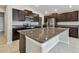 Stylish kitchen with granite countertops, dark cabinetry, and stainless steel appliances at 10822 Crushed Grape Dr, Riverview, FL 33578