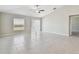 Large living room with tiled floors, ceiling fan, and natural light at 10822 Crushed Grape Dr, Riverview, FL 33578