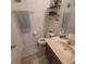Cozy bathroom featuring wood vanity, decorative shelves and blue patterned rugs at 10850 Lake Saint Charles Blvd, Riverview, FL 33578