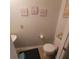 Compact half-bathroom with a toilet, sink, and neutral decor at 10850 Lake Saint Charles Blvd, Riverview, FL 33578