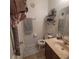 Cozy bathroom featuring wood vanity, decorative shelves and blue patterned rugs at 10850 Lake Saint Charles Blvd, Riverview, FL 33578