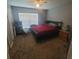Bedroom with neutral colored walls, a ceiling fan, large window, and a black bed frame at 10850 Lake Saint Charles Blvd, Riverview, FL 33578
