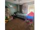 bedroom with cartoon wall decor, toy storage and play tent at 10850 Lake Saint Charles Blvd, Riverview, FL 33578