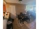Inviting dining area with a wooden table, bench seating, and tile flooring, perfect for Gathering meals at 10850 Lake Saint Charles Blvd, Riverview, FL 33578