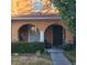 Inviting front entrance featuring a charming porch with arched openings and neat landscaping at 10850 Lake Saint Charles Blvd, Riverview, FL 33578