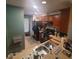 Cozy kitchen features a black refrigerator and oven, double sink, wooden cabinets, and neutral countertops at 10850 Lake Saint Charles Blvd, Riverview, FL 33578
