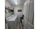 Functional laundry room with a washer and dryer, storage shelves, and laundry room wall decor at 10850 Lake Saint Charles Blvd, Riverview, FL 33578