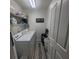 Bright laundry room with side-by-side washer and dryer and overhead shelving at 10850 Lake Saint Charles Blvd, Riverview, FL 33578
