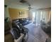 Comfortable living room with a large sectional sofa, tile flooring, and plenty of natural light at 10850 Lake Saint Charles Blvd, Riverview, FL 33578