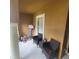 Cozy outdoor patio featuring comfortable wicker seating, a small side table, and a view of the surroundings at 10850 Lake Saint Charles Blvd, Riverview, FL 33578