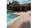 Community pool with a cabana and brick paver pool deck, perfect for relaxation and entertainment at 10850 Lake Saint Charles Blvd, Riverview, FL 33578