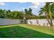 Expansive backyard with lush green grass and tropical foliage, offering privacy and space at 1116 Hillandale Reserve Dr, Tampa, FL 33613
