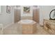Bathroom featuring a large soaking tub with a tiled surround at 1116 Hillandale Reserve Dr, Tampa, FL 33613