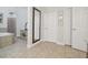 Spacious bathroom with neutral tile flooring, a large soaking tub, a vanity, and linen closet at 1116 Hillandale Reserve Dr, Tampa, FL 33613