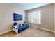 Bedroom with a window with shutters and a blue futon couch at 1116 Hillandale Reserve Dr, Tampa, FL 33613
