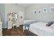 Comfortable bedroom with wood floors, a quaint vanity with triple mirrors, and a white bed adorned with blue accents at 1116 Hillandale Reserve Dr, Tampa, FL 33613