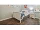 Cozy bedroom featuring wood floors, soft blue walls, and a white sleigh bed, complemented by a matching nightstand at 1116 Hillandale Reserve Dr, Tampa, FL 33613