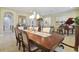 Bright dining room with piano, hutch, and large wood table under decorative chandelier at 1116 Hillandale Reserve Dr, Tampa, FL 33613