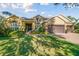 Lovely home featuring a well-manicured lawn, mature landscaping, and a three-car garage at 1116 Hillandale Reserve Dr, Tampa, FL 33613