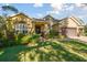Beautiful home featuring lush landscaping, large windows, and a three-car garage at 1116 Hillandale Reserve Dr, Tampa, FL 33613