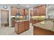 Well-lit kitchen featuring granite countertops, wood cabinets, and stainless steel appliances at 1116 Hillandale Reserve Dr, Tampa, FL 33613