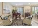 Formal sitting room with grand piano, sitting area and natural light from windows at 1116 Hillandale Reserve Dr, Tampa, FL 33613