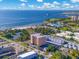 Aerial view of a residential building near the beach with blue ocean waters and sunny skies at 1120 N Shore Ne Dr # 802, St Petersburg, FL 33701
