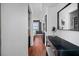 A bright hallway with a vanity and a modern mirror offers views into a bedroom at 1120 N Shore Ne Dr # 802, St Petersburg, FL 33701