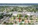 This is an aerial view showcasing the property location, surrounded by lush greenery and a tranquil lake at 11250 108Th Ln, Largo, FL 33778