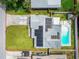 Aerial view of the property highlighting the home, the pool, yard, and solar panels at 11250 108Th Ln, Largo, FL 33778
