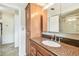 Bathroom vanity with granite counters, wooden cabinetry, and designer faucet fixture at 11250 108Th Ln, Largo, FL 33778