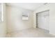 Cozy bedroom with terrazzo floors, neutral wall color, window, and closet at 11250 108Th Ln, Largo, FL 33778