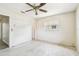 Bright bedroom with terrazzo flooring, ceiling fan, and window providing ample natural light at 11250 108Th Ln, Largo, FL 33778