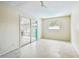 Spacious bonus room featuring terrazzo floors, sliding glass doors, and a bright window at 11250 108Th Ln, Largo, FL 33778