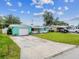 Street view of a cozy home featuring a long driveway, vibrant exterior, and well-maintained lawn in a residential neighborhood at 11250 108Th Ln, Largo, FL 33778