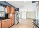 Modern kitchen featuring stainless steel appliances, dark countertops, and wood cabinetry, offering style and functionality at 11250 108Th Ln, Largo, FL 33778