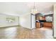 Bright and open living area with tile floors, chandelier, and view to the kitchen, creating a seamless and inviting living space at 11250 108Th Ln, Largo, FL 33778