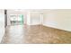 Bright living room showcasing neutral walls, tile floors, and open layout, flowing seamlessly into dining and entertainment spaces at 11250 108Th Ln, Largo, FL 33778