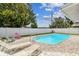 Features a well-maintained in-ground pool with lounge chairs, creating an inviting backyard oasis at 11250 108Th Ln, Largo, FL 33778