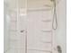 Bathroom showing walk in shower with built in shelving and clear glass door at 11250 108Th Ln, Largo, FL 33778