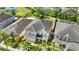 Aerial view showcasing a two-story home with a well-manicured yard and mature landscaping at 11419 Emerald Shore Dr, Riverview, FL 33579