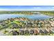 Picture of homes and a lake surrounded by green landscaping with a location pin on a roof at 11419 Emerald Shore Dr, Riverview, FL 33579