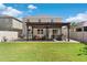 Expansive backyard featuring a well-manicured lawn, an outdoor kitchen, and a covered pergola at 11419 Emerald Shore Dr, Riverview, FL 33579
