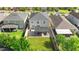 A neatly kept backyard with an outdoor living space and a green lawn at 11419 Emerald Shore Dr, Riverview, FL 33579