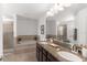 Bright bathroom featuring double sinks with granite countertops, soaking tub, tiled shower and neutral color palette at 11419 Emerald Shore Dr, Riverview, FL 33579