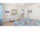 Bright bedroom featuring light neutral walls, a white dresser, and a floral-themed bedspread at 11419 Emerald Shore Dr, Riverview, FL 33579