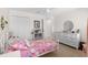 Bedroom features carpet, white furniture, a bed with unicorn bed set, and a ceiling fan at 11419 Emerald Shore Dr, Riverview, FL 33579