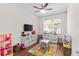room features a flat screen TV, multiple storage units, a table, and a colorful rug at 11419 Emerald Shore Dr, Riverview, FL 33579