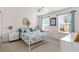 Bright bedroom featuring two windows, white furniture, and a charming floral-themed bedspread at 11419 Emerald Shore Dr, Riverview, FL 33579